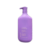 Lavender & Chamomile Body Lotion bottle placed beside fresh lavender flowers and a towel.