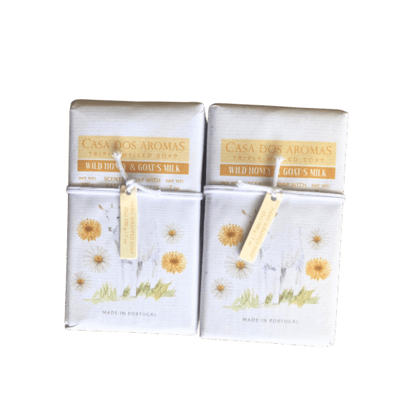 4 handcrafted Wild Honey & Goat's Milk soap bars made in Portugal, displayed in a rustic box with golden and cream tones.