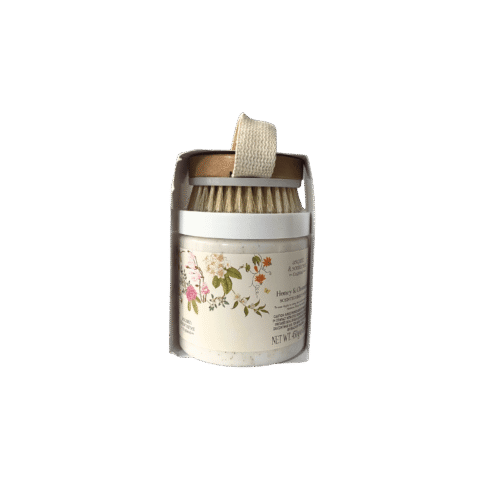 Asquith & Somerset Honey & Chamomile Body Scrub jar with wooden exfoliating brush.